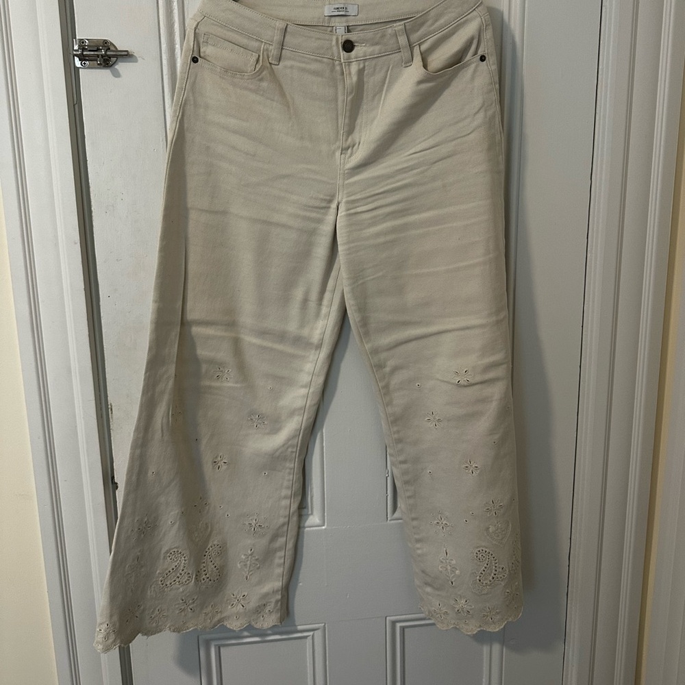 Tan flared jeans with design at the bottom
